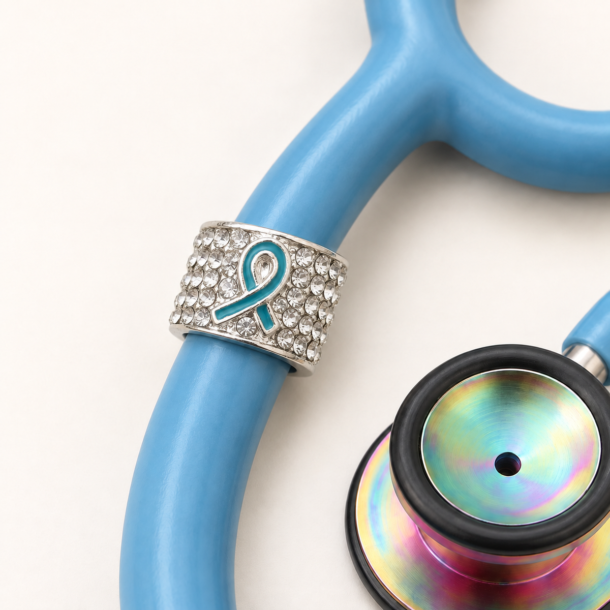 Teal Ribbon Stethoscope Charm close-up on blue stethoscope