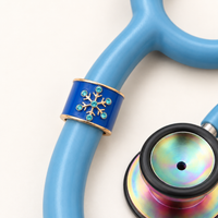 Snowflake Stethoscope Charm close-up on blue stethoscope