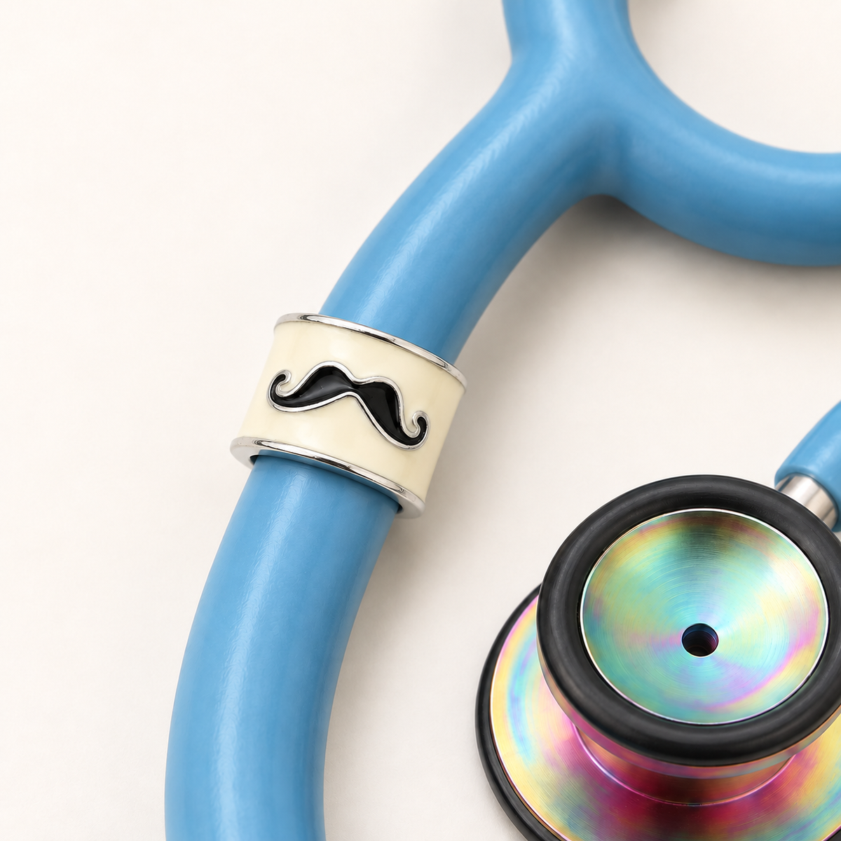 Mustache Stethoscope Charm close-up on blue stethoscope
