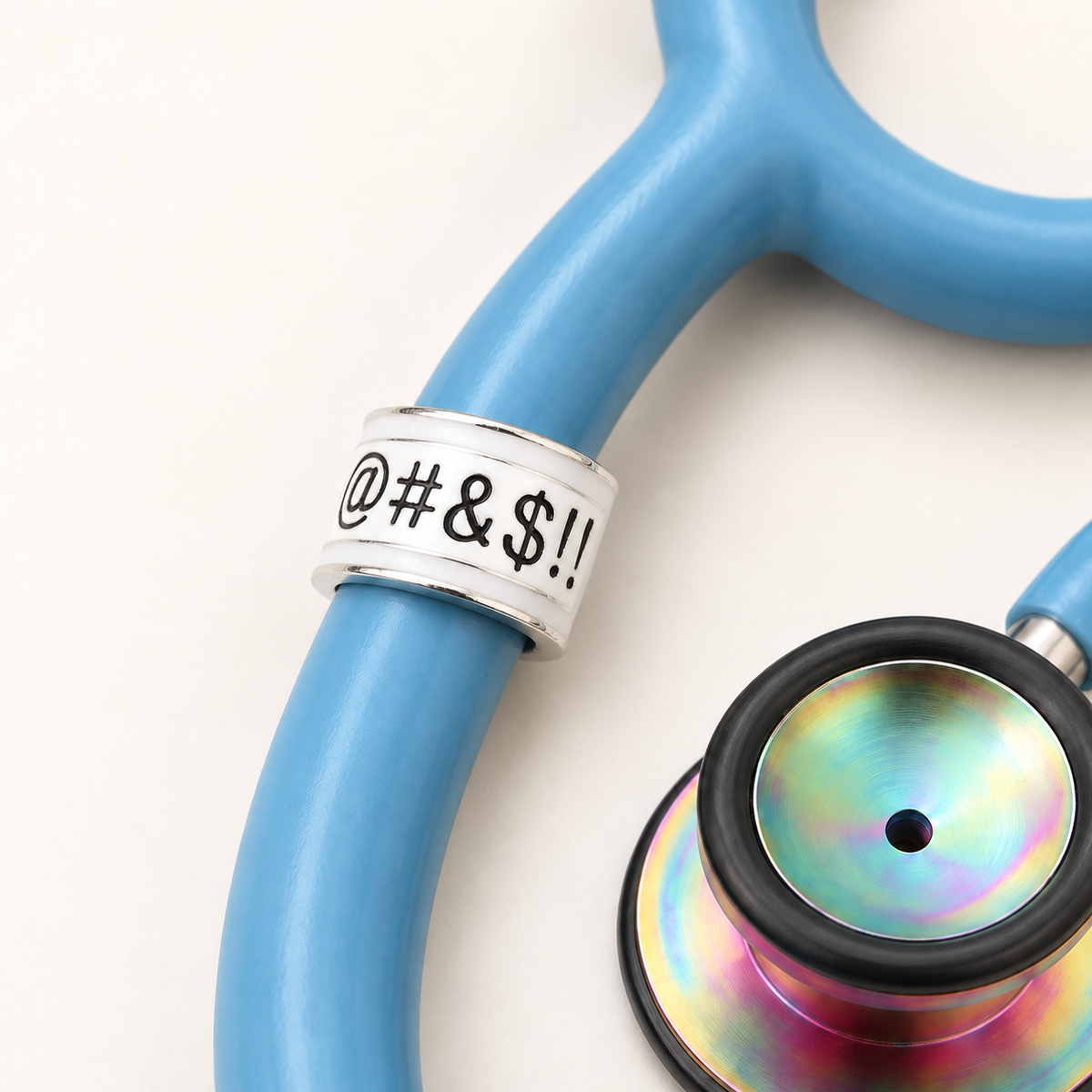 Dirty Word Stethoscope Charm close-up on blue stethoscope