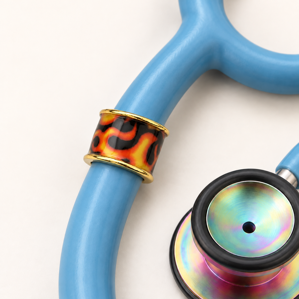 Flame Stethoscope Charm close-up on blue stethoscope