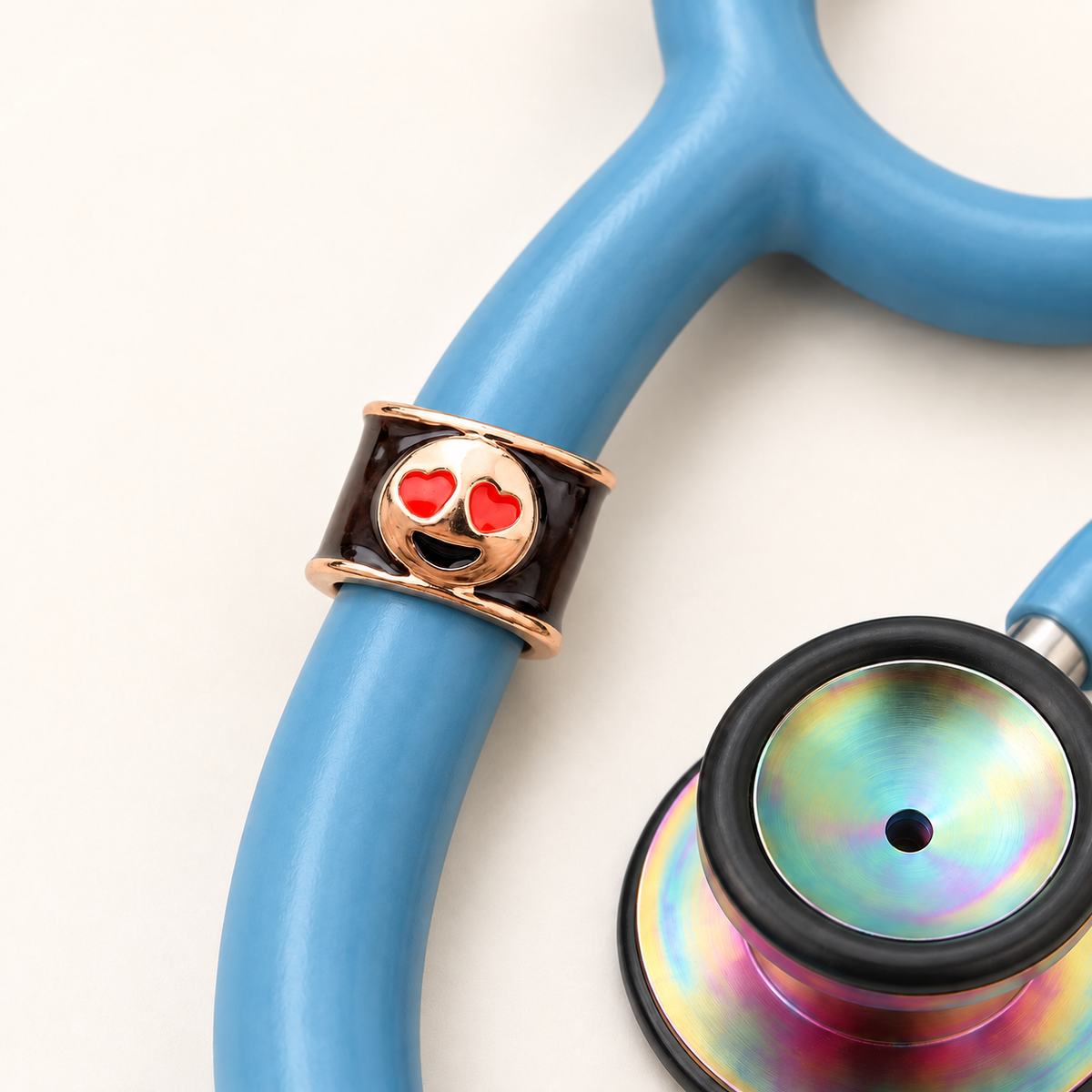 Heart Eyes Emoji Stethoscope Charm close-up on blue stethoscope