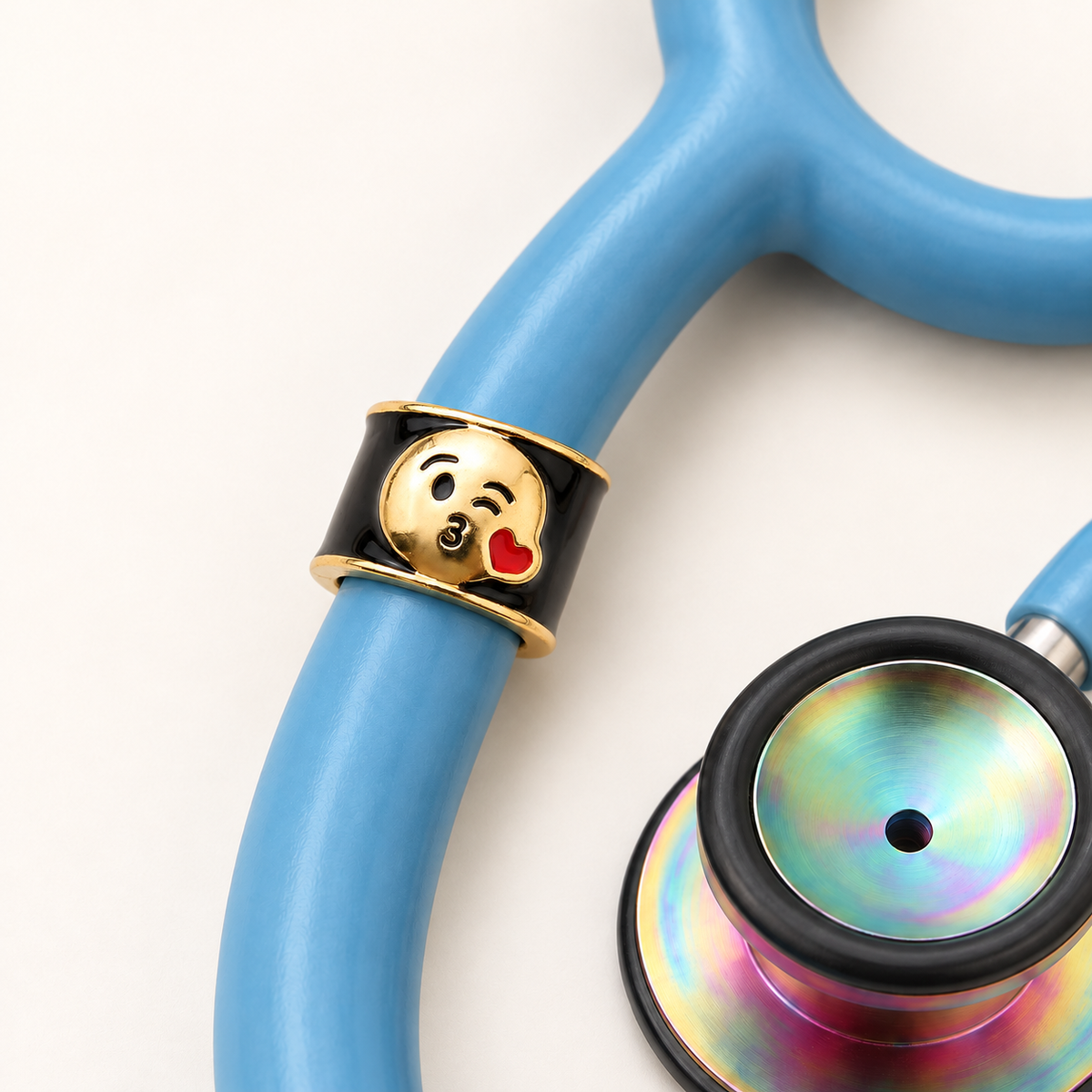 Kissy Face Emoji Stethoscope Charm close-up on blue stethoscope