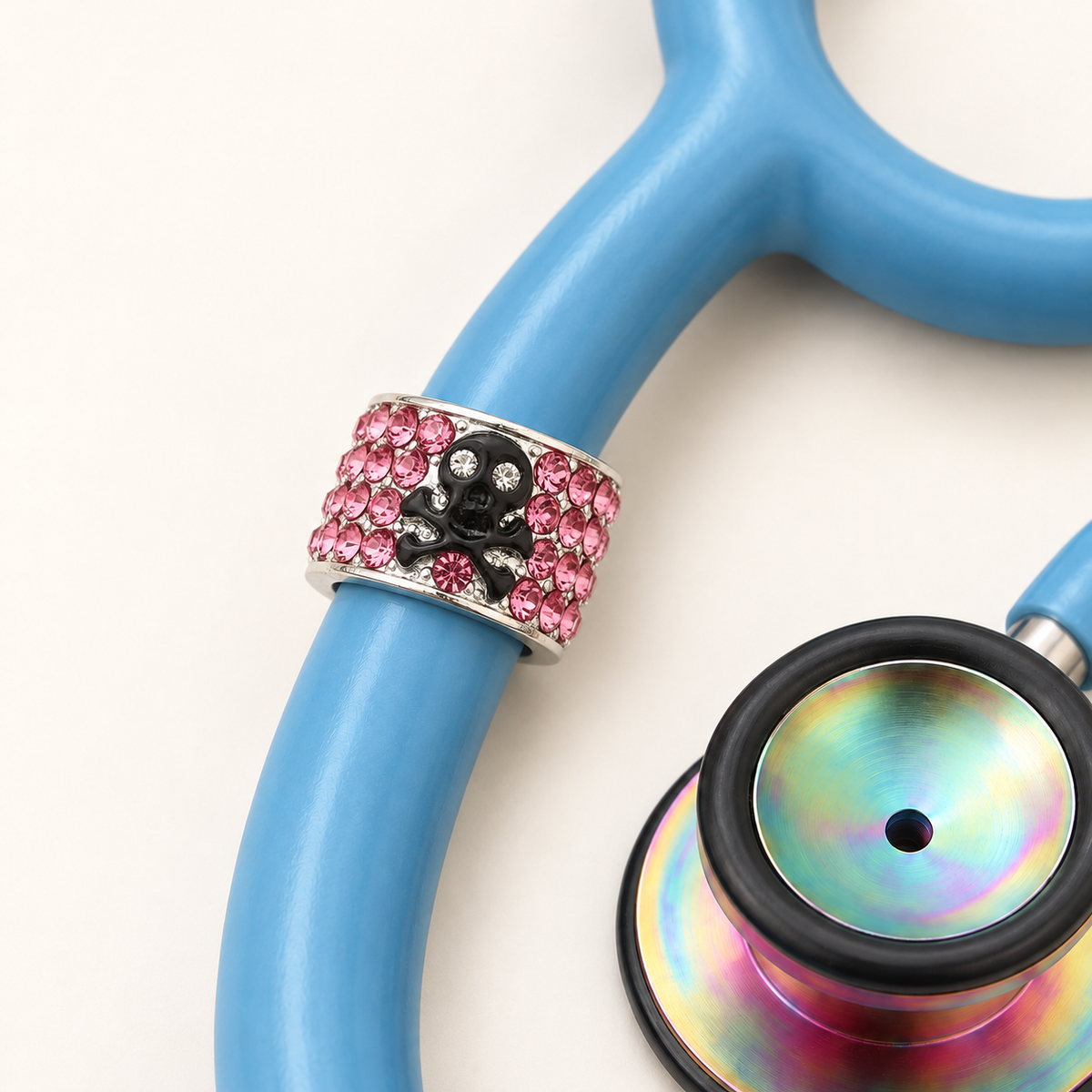 Skull and Crossbones Stethoscope Charm close-up on blue stethoscope
