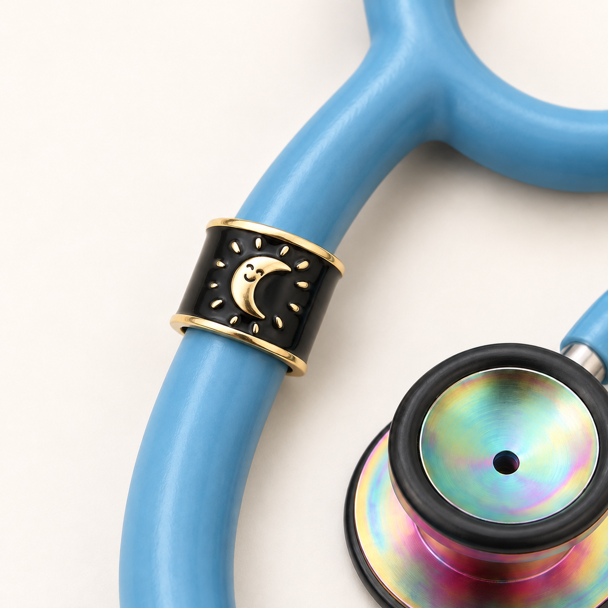 Smiling Moon Stethoscope Charm close-up on blue stethoscope