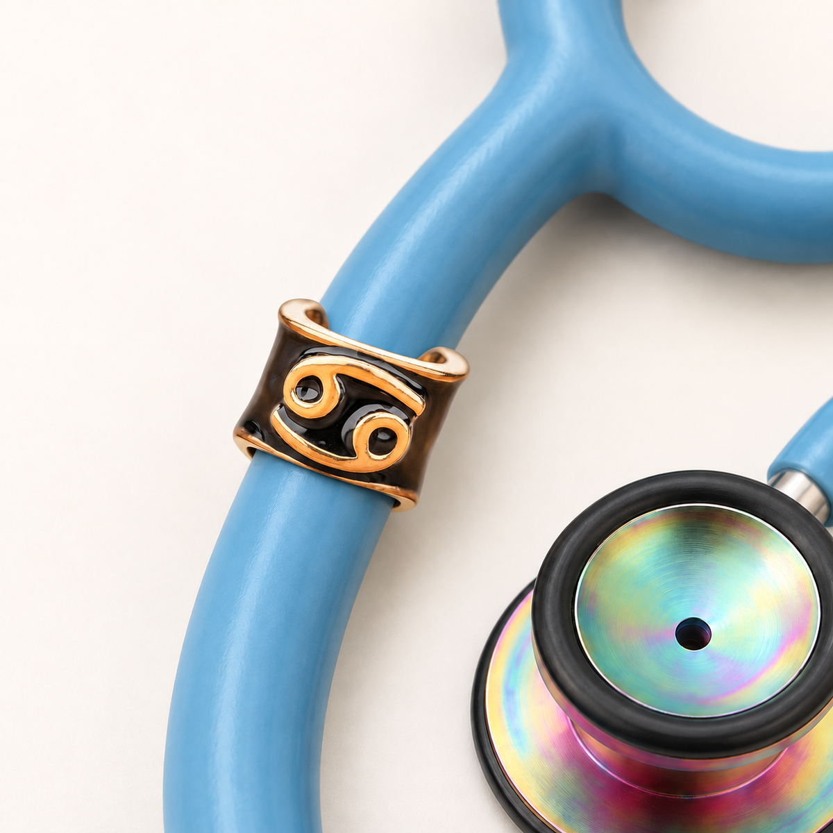 Cancer Stethoscope Charm close-up on blue stethoscope