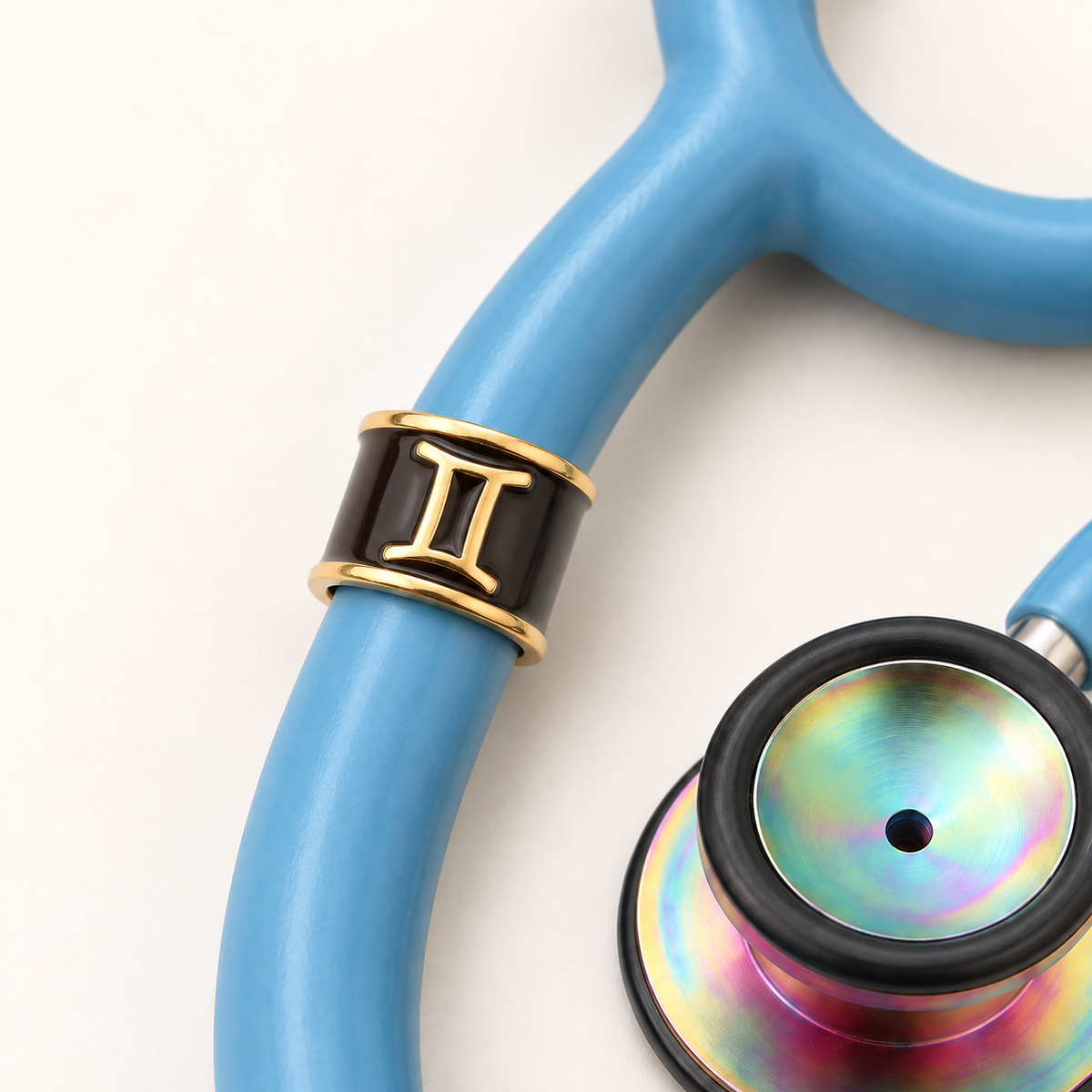 Gemini Stethoscope Charm close-up on blue stethoscope