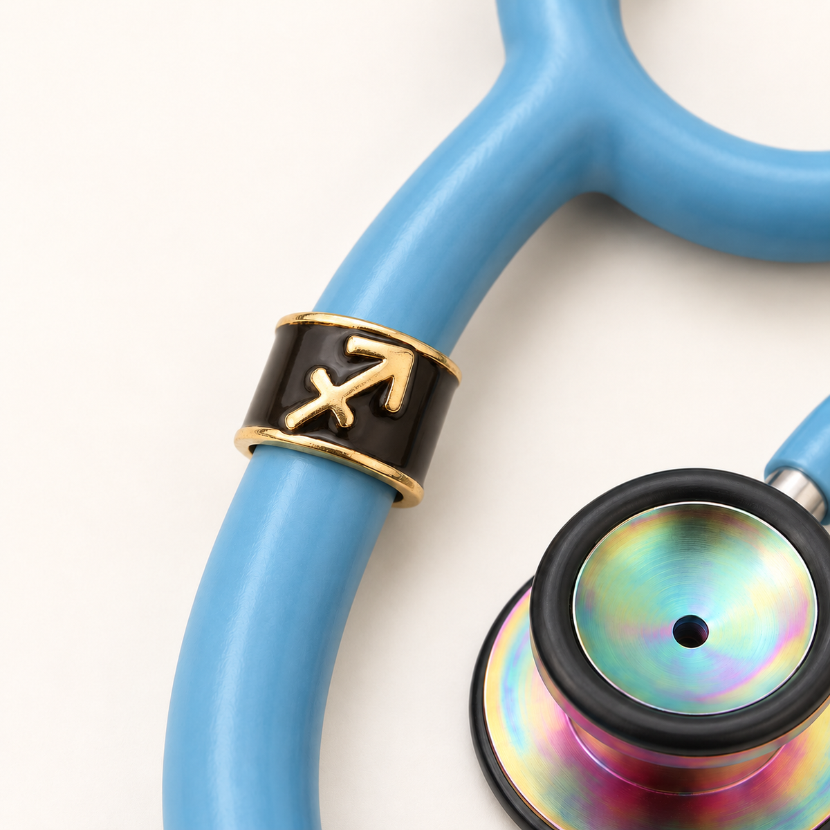 Sagittarius Stethoscope Charm close-up on blue stethoscope